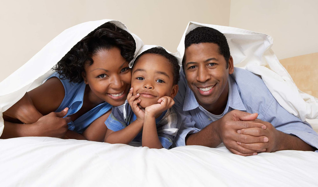 African american family enjoying the bed